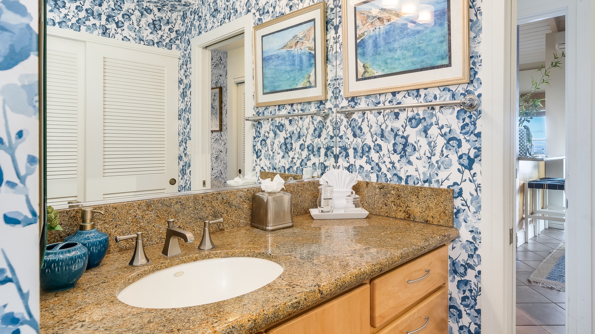 Kihei Vacation Rentals, Wailea Ekolu 1106 - The bathroom features a granite countertop, a wide vanity, and artistic accents, providing a relaxing space for guests.