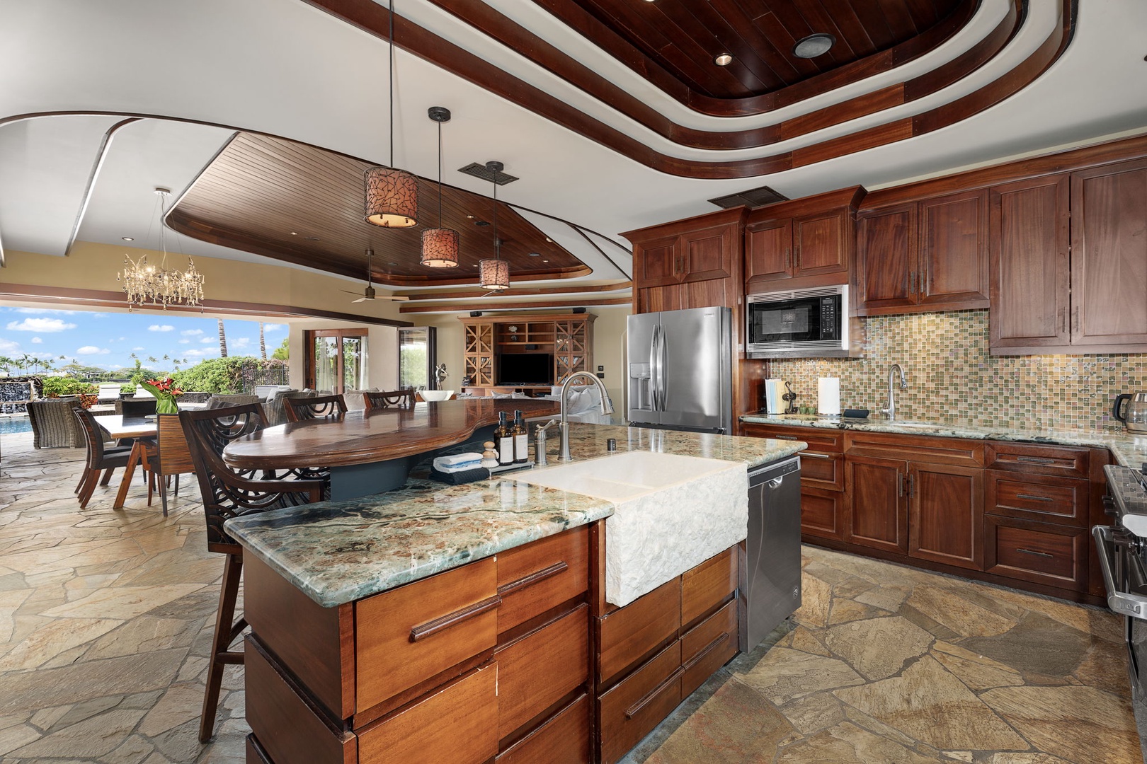 Kamuela Vacation Rentals, Hale Konane - A chef’s dream kitchen featuring rich wood finishes and high-end countertops.