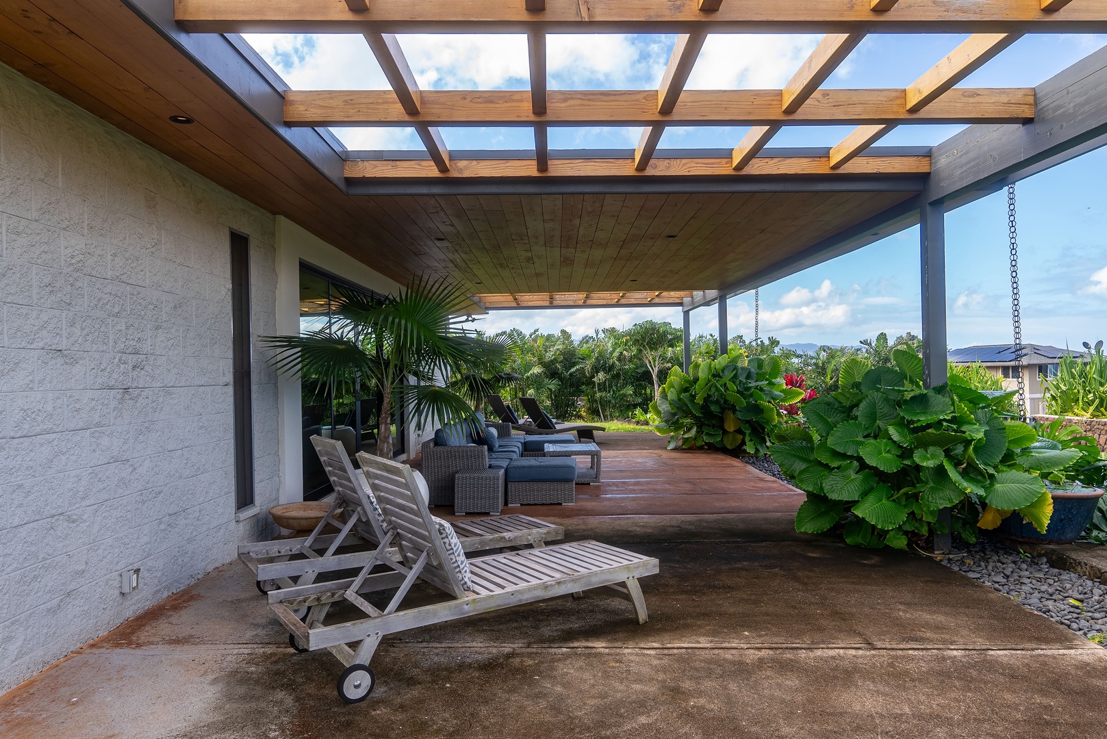 Haleiwa Vacation Rentals, Hale Mahina - Relax beneath the covered lanai with loungers and seamless indoor-outdoor living.