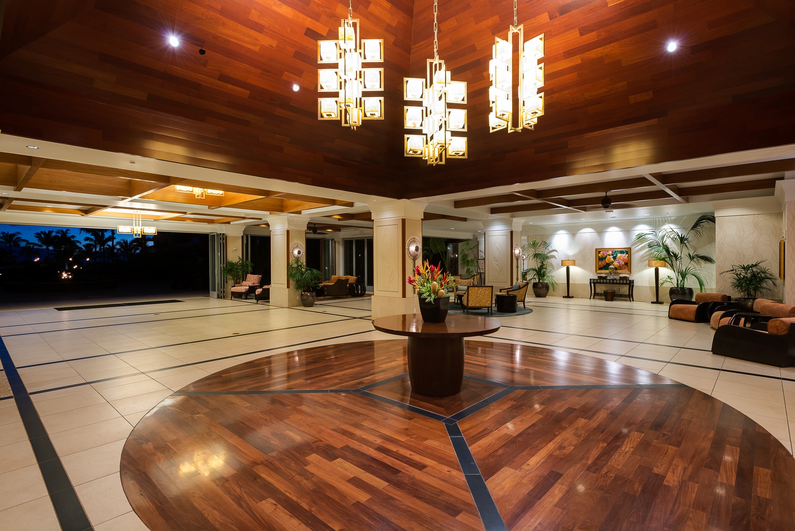 Lahaina Vacation Rentals, Honua Kai Konea 206 - This elegant resort lobby features a rich wooden floor and ceiling, accented by modern hanging light fixtures.