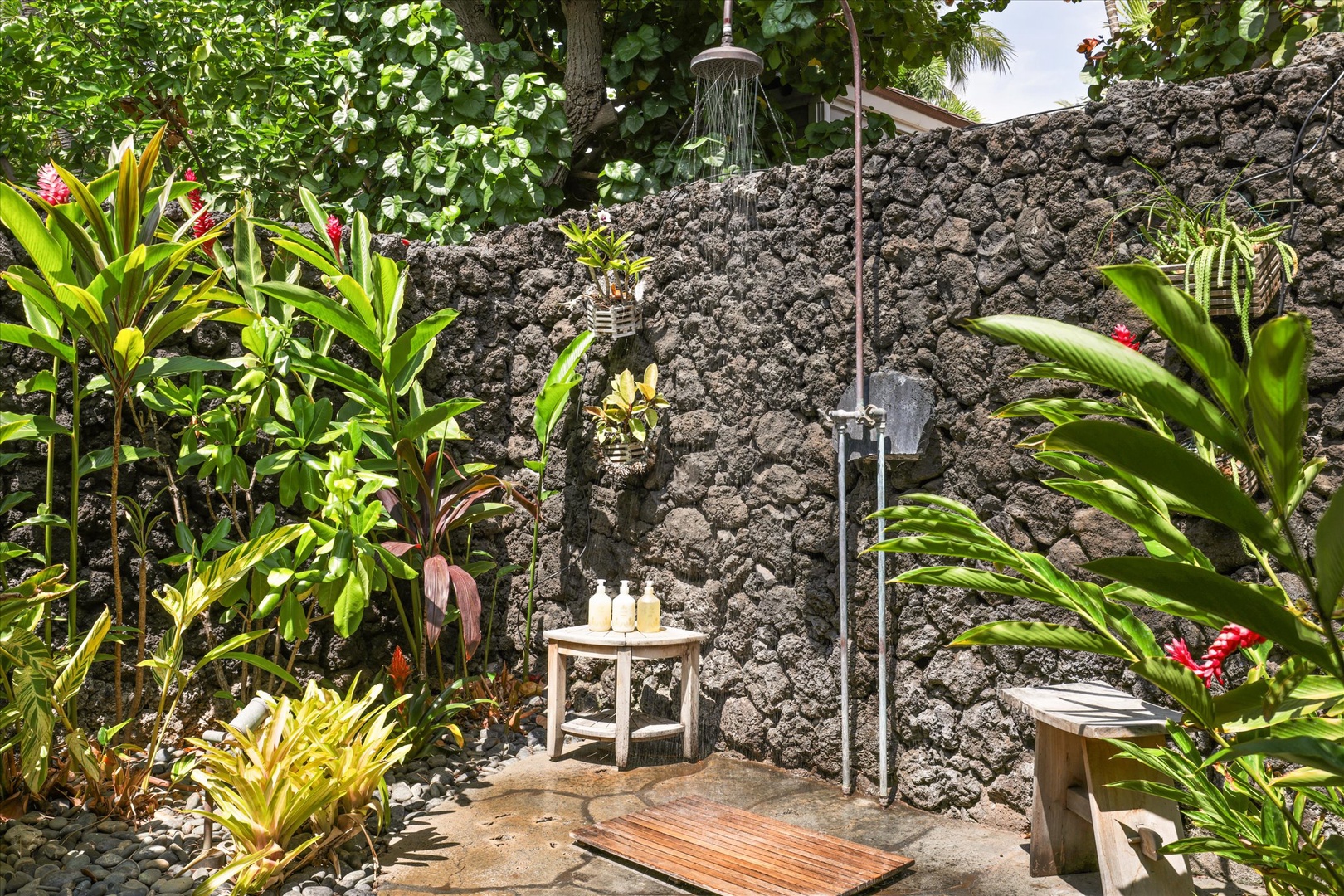 Kamuela Vacation Rentals, 3BD Na Hale 3 at Pauoa Beach Club at Mauna Lani Resort - Shower outdoors against a lava-rock wall with tropical plants crowding in close.