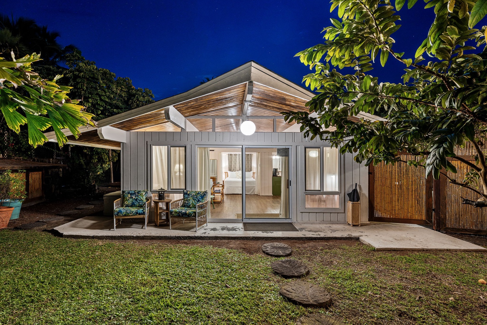 Kailua Kona Vacation Rentals, Mai Tai Manor - Ohana featuring sleek architecture surrounded by lush greenery and peaceful garden pathways.