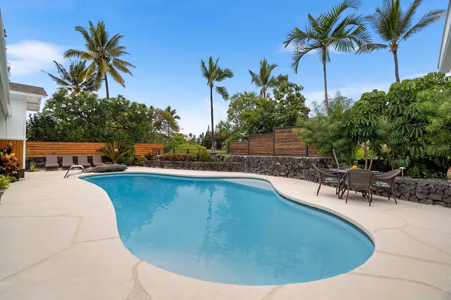 Kailua Kona Vacation Rentals, Manukai Hale - The free-form pool curves through the yard, lounge chairs lined up in the sun.