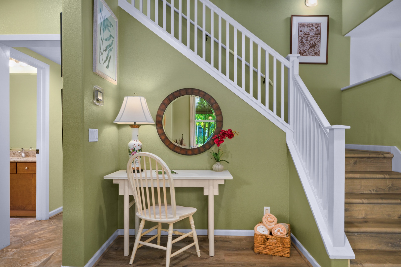 Princeville Vacation Rentals, Kaimana Villa - Settle into your charming workspace beneath the staircase, where soft green walls and warm lighting create a peaceful spot for morning coffee or planning your adventures.