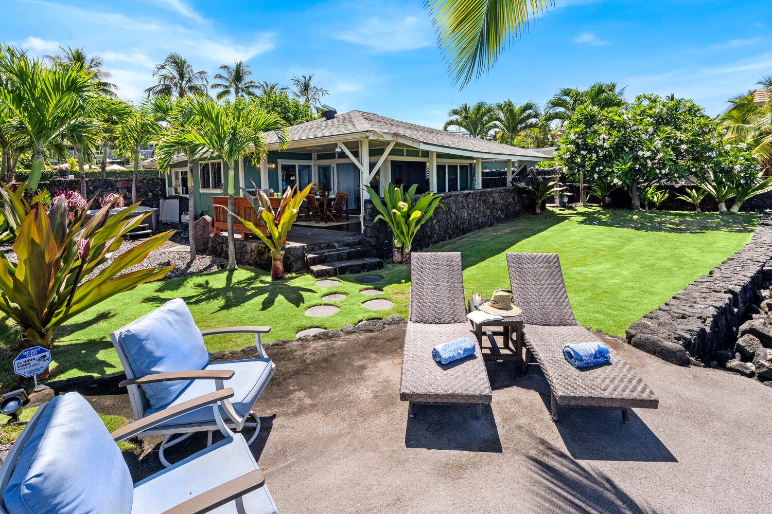 Kailua Kona Vacation Rentals, Honl's Beach Hale (Big Island) - Relax on the lawnside loungers surrounded by tropical gardens with the ocean just ahead.
