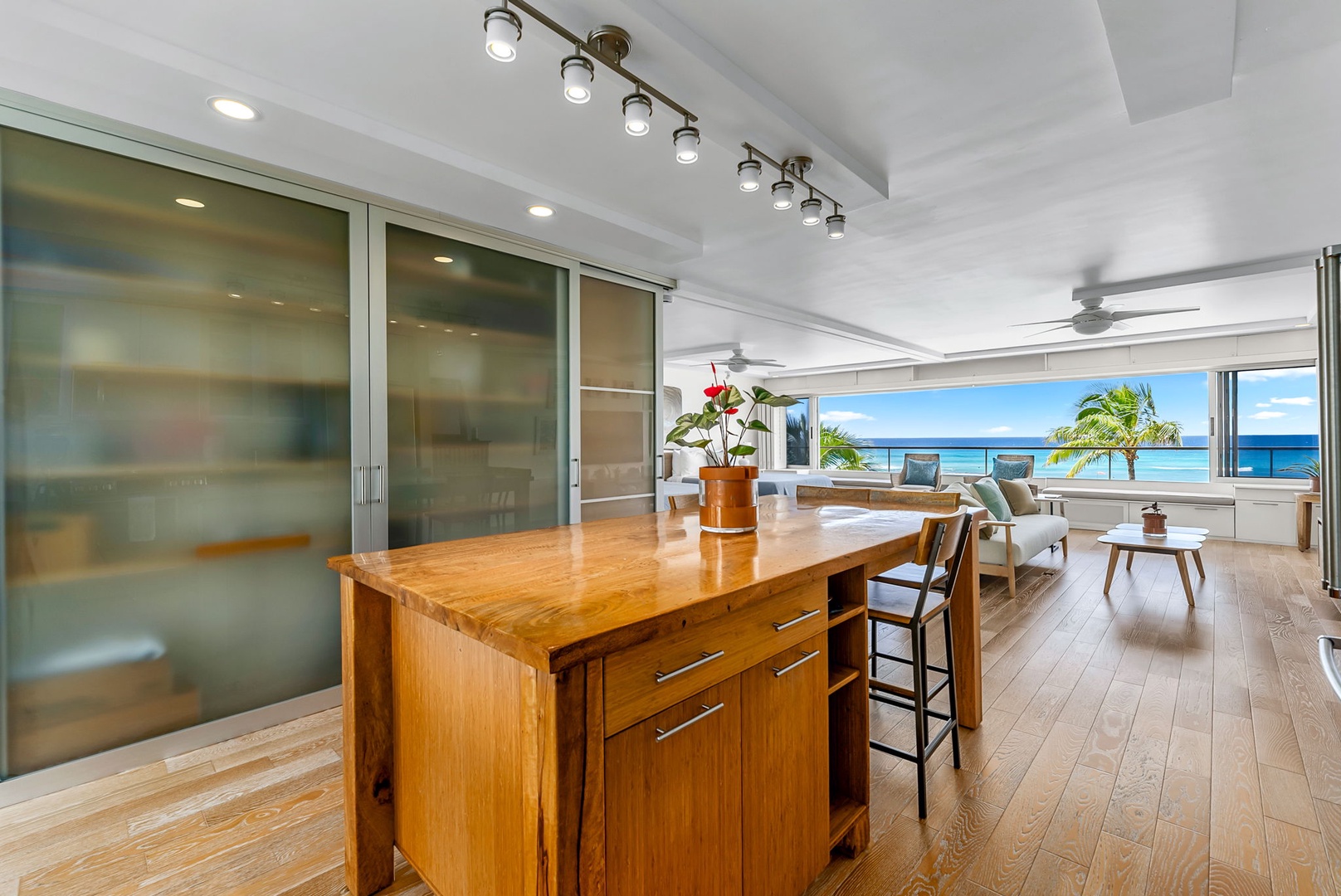 Honolulu Vacation Rentals, Colony Surf Luxe - Oceanview kitchen island with bar seating—an ideal space to sip your morning coffee or prepare snacks with the sea breeze flowing in.