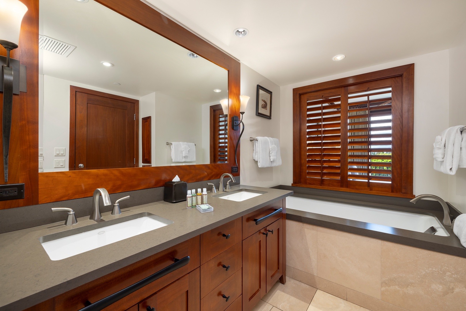Kapolei Vacation Rentals, Ko Olina Beach Villas B506 - Unwind in your spa-like bathroom featuring dual vanities, soaking tub, and warm wood accents that create a luxurious retreat.