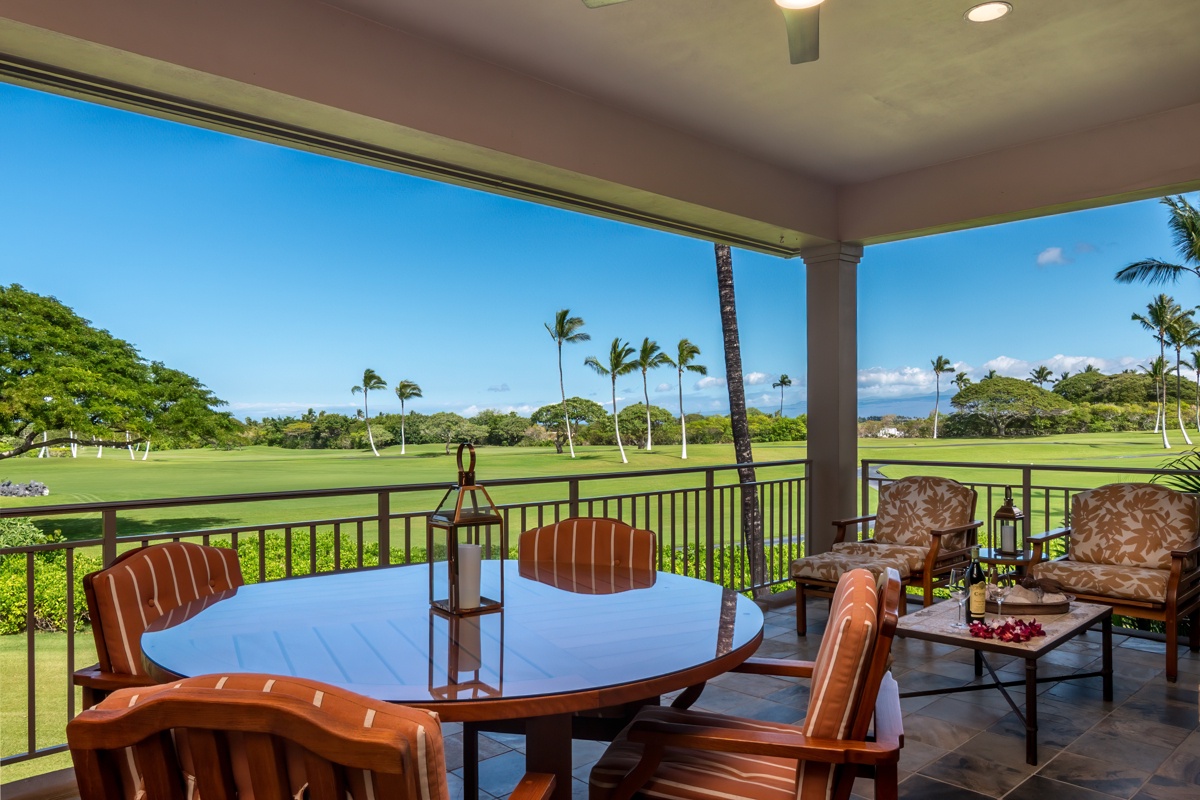 Kailua Kona Vacation Rentals, Fairways Villa 120A - Savor your morning coffee at this elegant dining table while enjoying stunning golf course views framed by tropical palms.