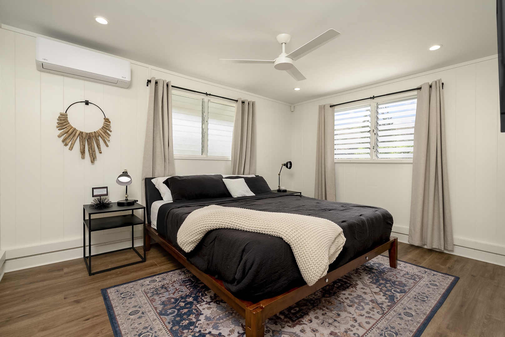 Honolulu Vacation Rentals, Honolulu Beachfront Retreat - Bedroom with a queen-sized bed, monochromatic accents, and a cozy vibe.