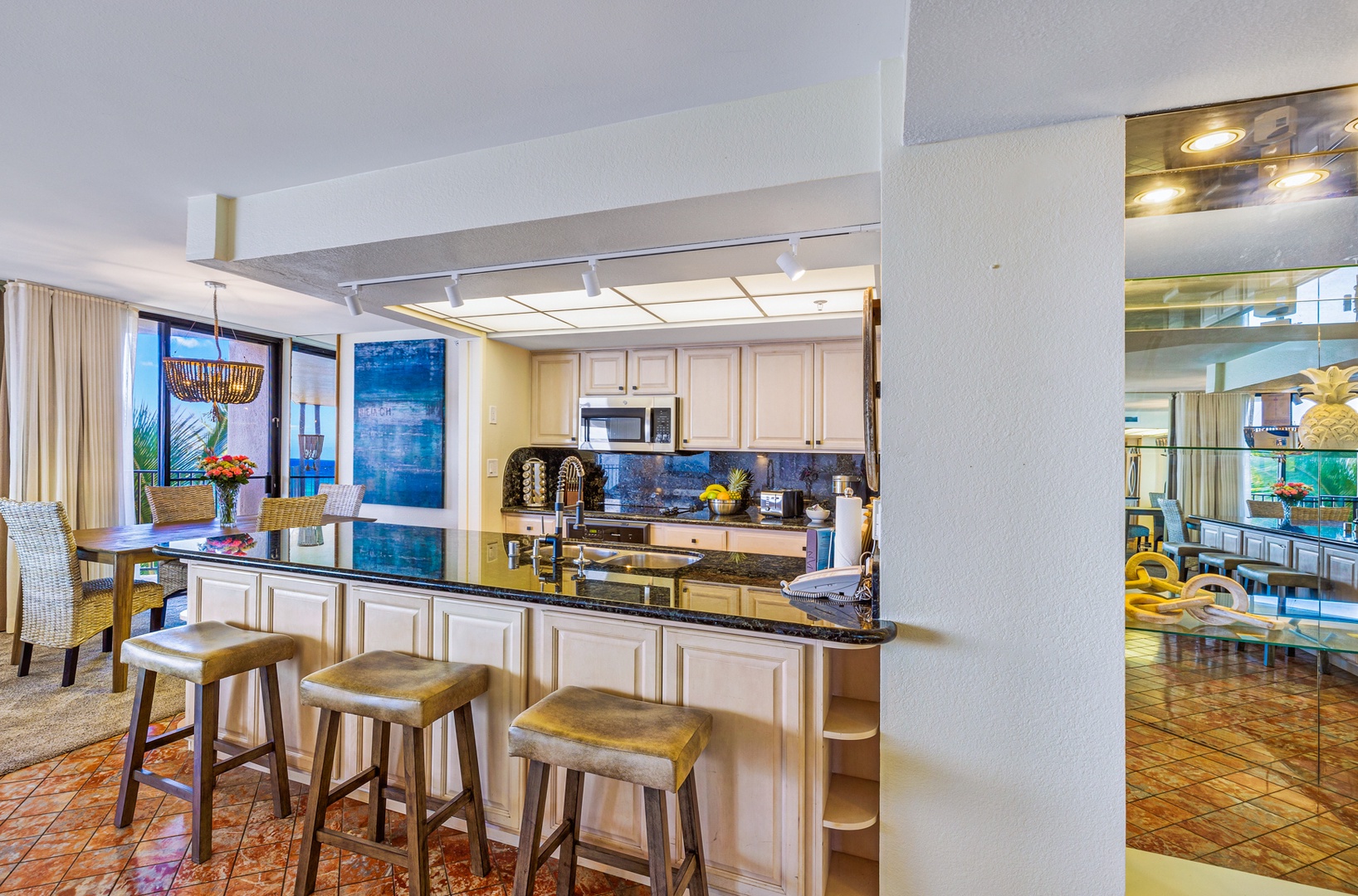 Lahaina Vacation Rentals, Kaanapali Shores 502 - The spacious kitchen island with its cozy barstools offers a perfect spot for a quick bite or a laid-back chat while preparing meals.