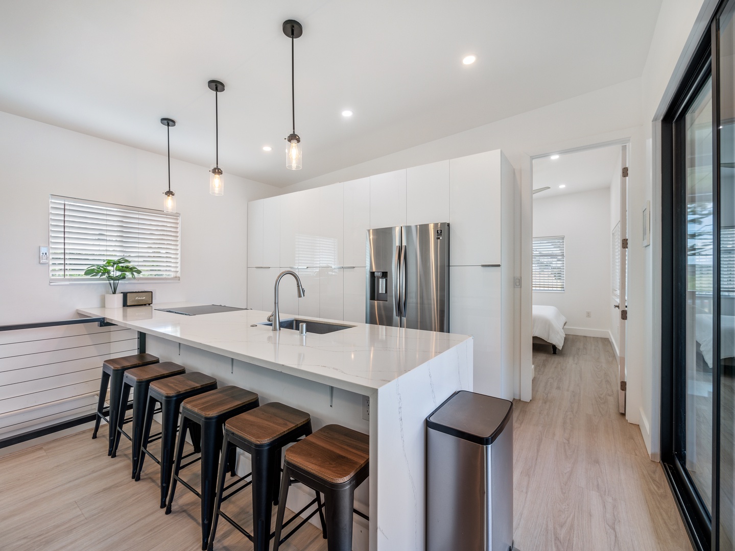 Haleiwa Vacation Rentals, Sunset Beach Island Retreat - The modern kitchen showcases a spacious island with seating for five, making it an ideal spot for casual dining or gathering