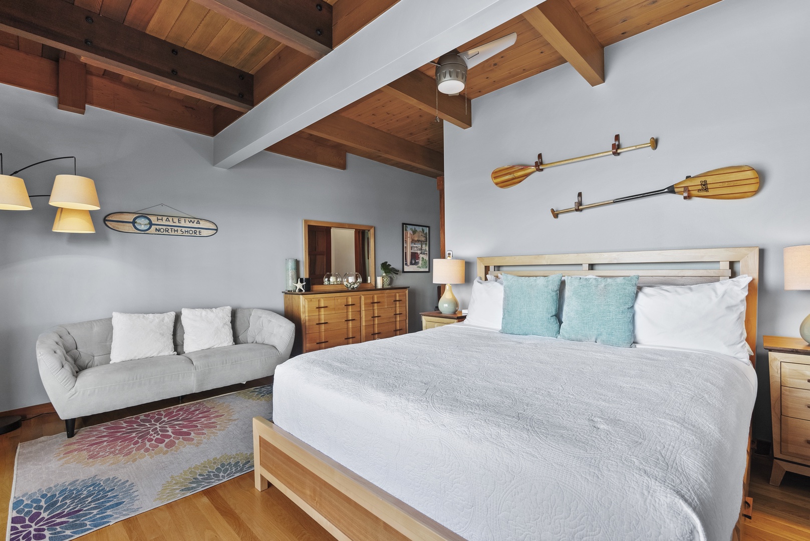 Haleiwa Vacation Rentals, Samurai House - Cozy bedroom with warm wood tones and nautical decor, featuring a King bed.