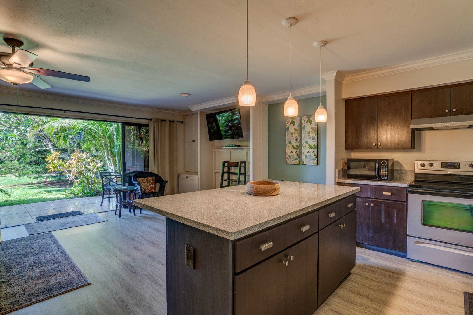 Kihei Vacation Rentals, Koa Resort 1B - Contemporary kitchen features pendant lighting, stainless steel appliances, and plenty of space to cook and gather.