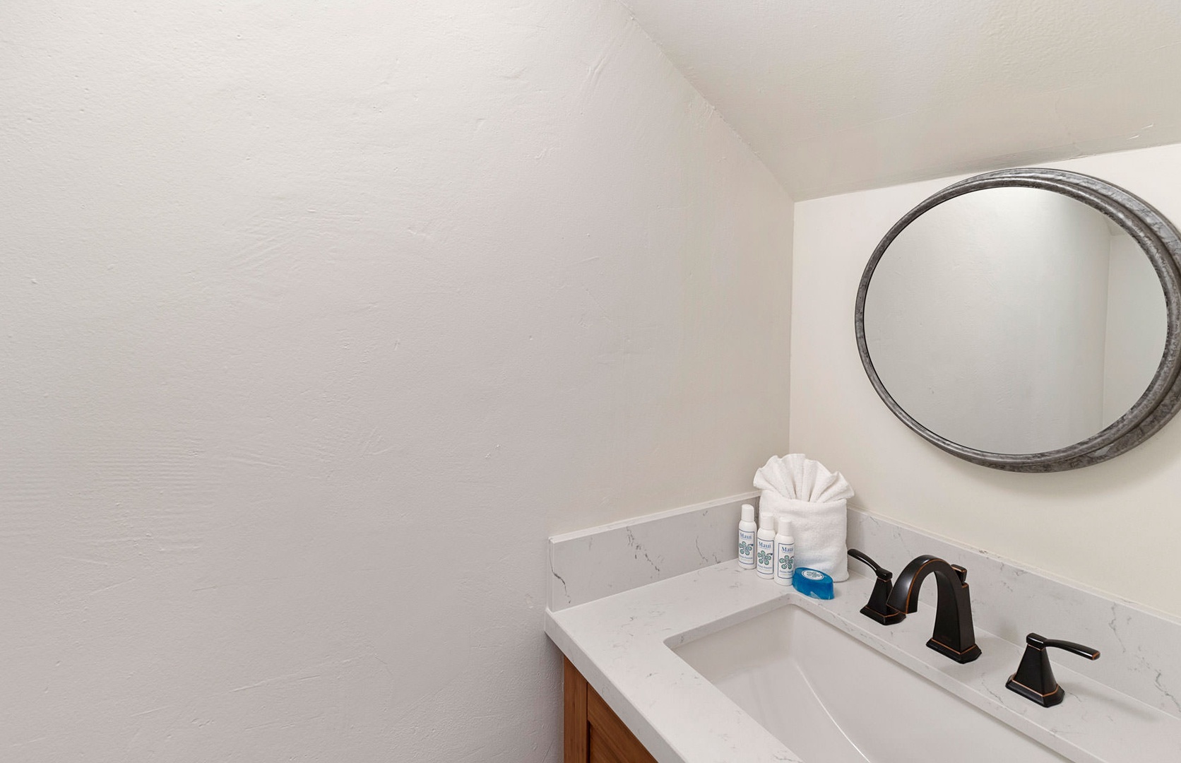 Lahaina Vacation Rentals, Puamana 240-3 - A modern bathroom featuring a sleek design and thoughtful touches for convenience.