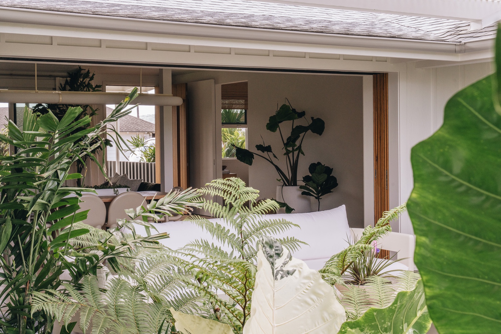 Honolulu Vacation Rentals, Surfside Bungalow** - Tropical greenery and open-air living create a serene setting for relaxation and connection.
