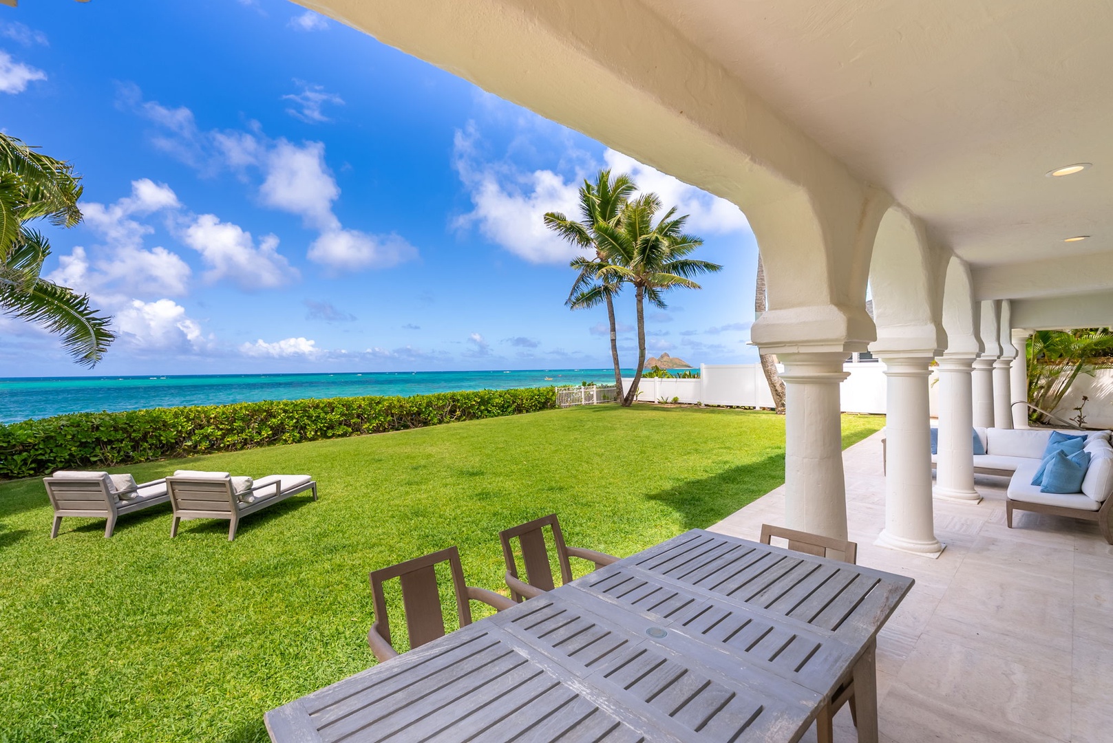 Kailua Vacation Rentals, Lanikai Sunrise Estate - Covered lanai with oceanfront dining for six offers the perfect place to enjoy morning coffee or sunset dinners.