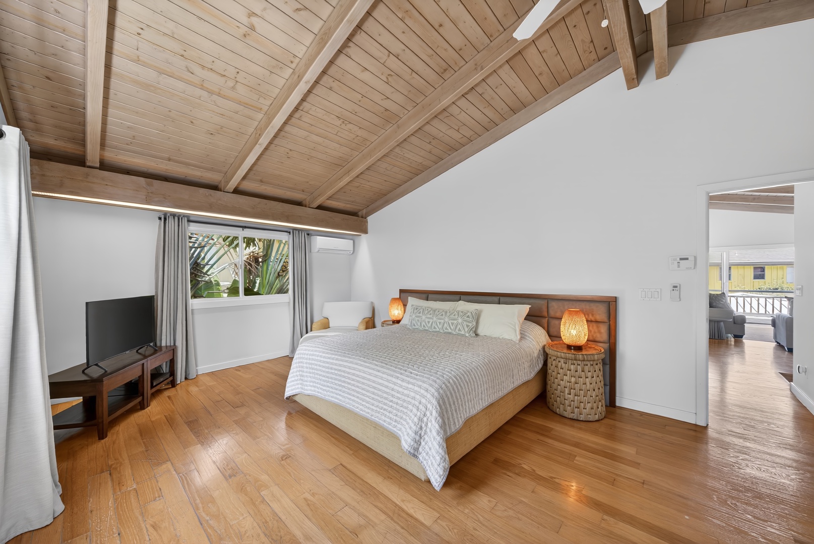 Haleiwa Vacation Rentals, Sunset Beach Hideaway - Rest easy in the spacious primary bedroom with a Cal king bed, warm wood ceilings and island-inspired design.