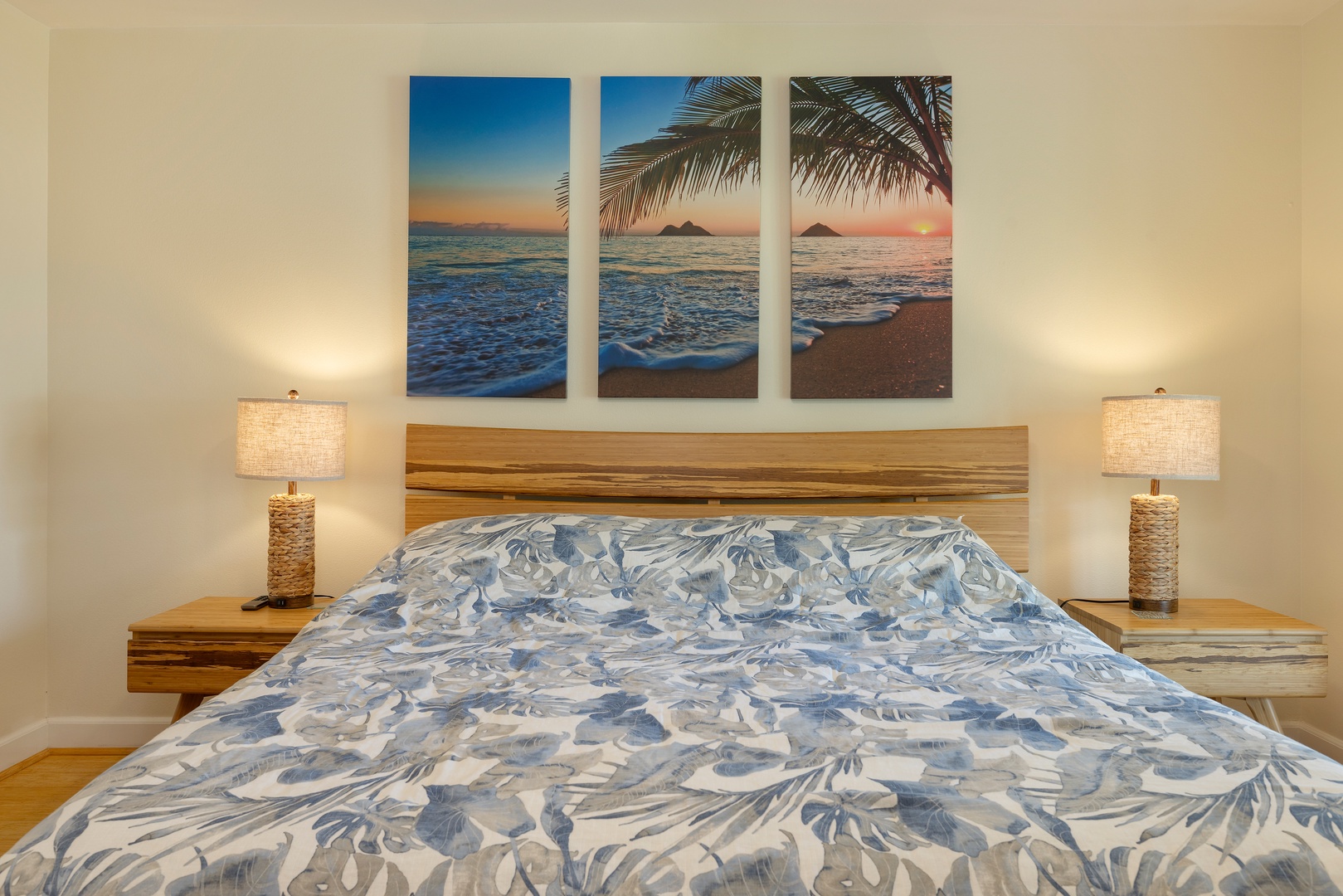 Drift off to tropical dreams in your cozy bedroom, where warm lighting and ocean artwork create the perfect seaside sanctuary.