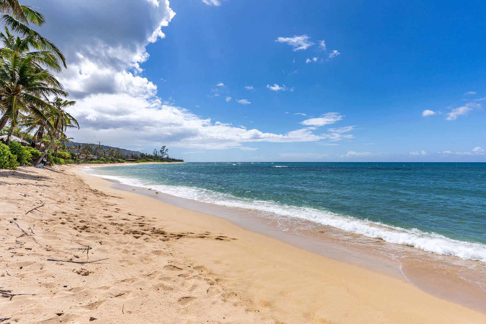 Waialua Vacation Rentals, Mokuleia Beach Villa** - Step right from your backyard onto the sandy shores of Mokuleia Beach, known for its calm waters and breathtaking sunsets.