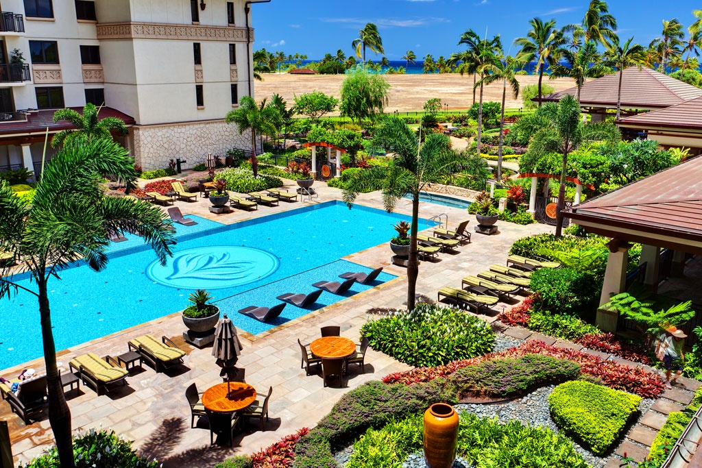 Kapolei Vacation Rentals, Ko Olina Beach Villas O1121 - The heated lap pool under palm trees and blue skies.