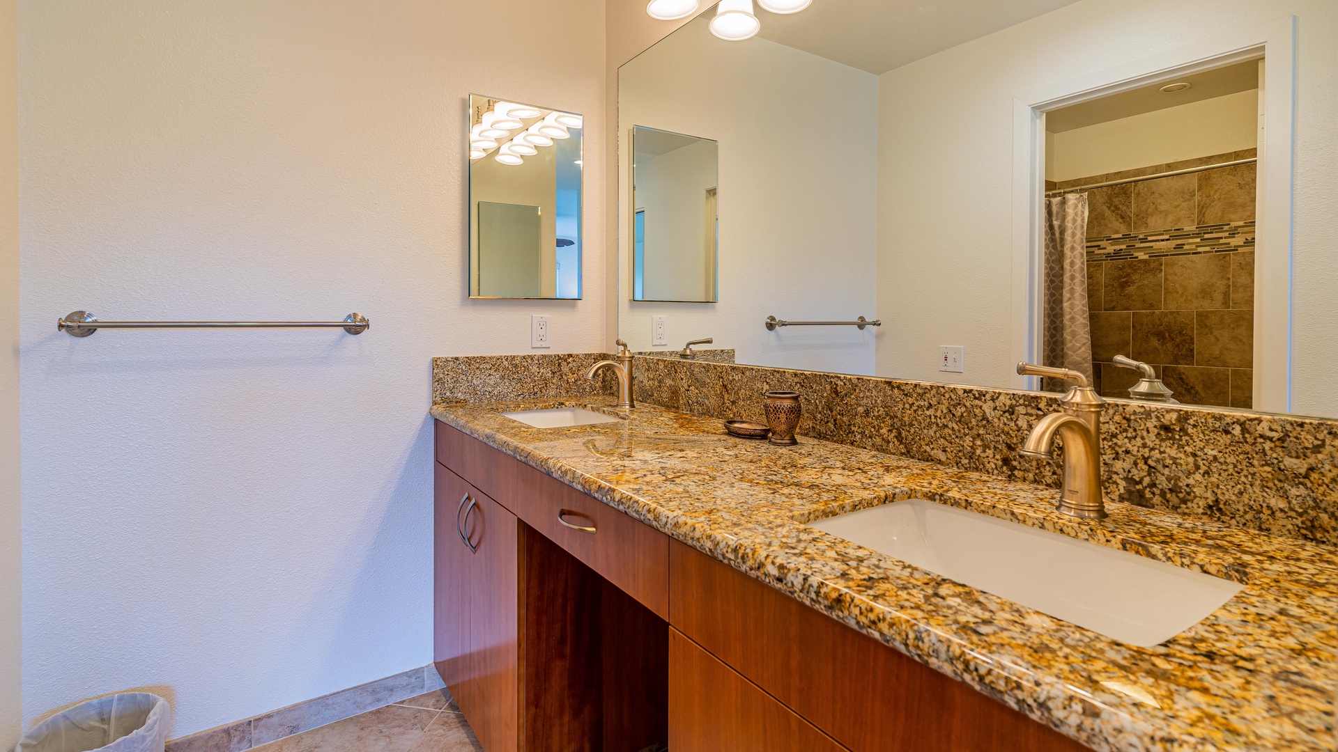 Kapolei Vacation Rentals, Fairways at Ko Olina 20G - The warm wood tones and double vanity in this high end guest bathoom.
