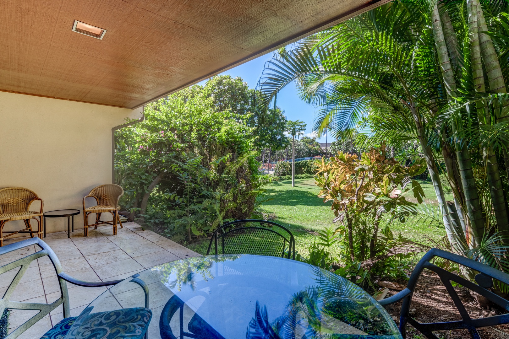 Kihei Vacation Rentals, Koa Resort 1B - Garden-view lanai with shaded seating—perfect for morning coffee or afternoon relaxation.