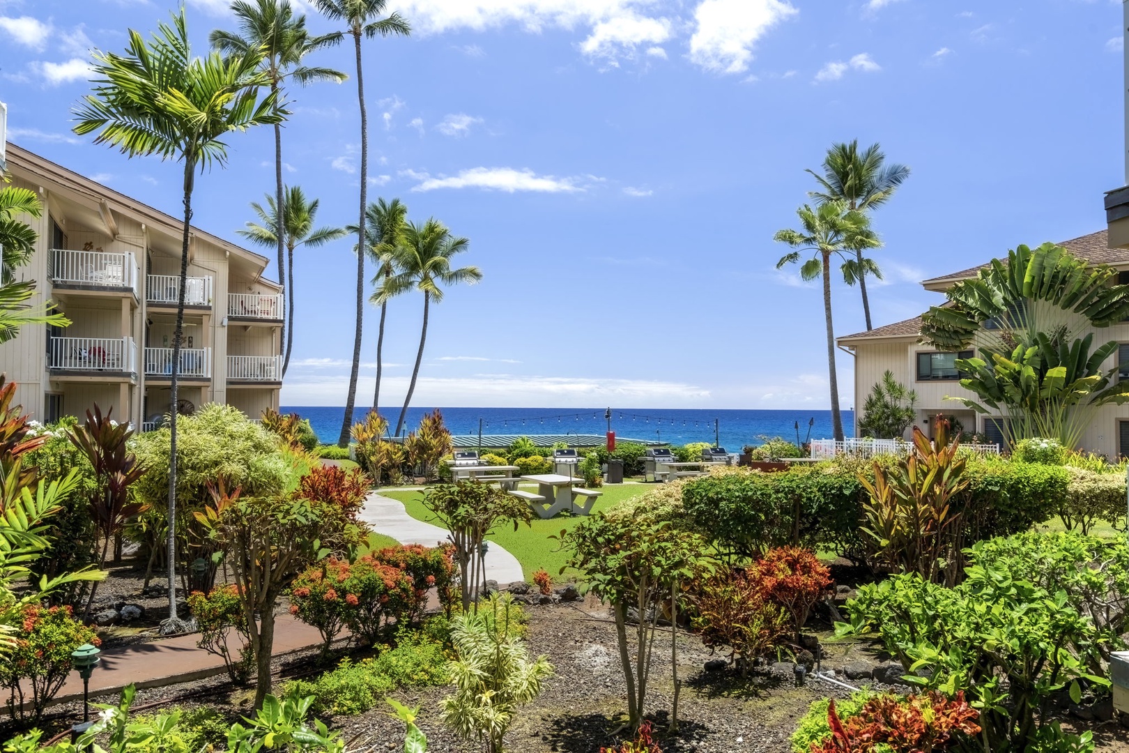 Kailua Kona Vacation Rentals, Sea Village 1105 - Manicured tropical gardens lead the way to your lanai—lush pathways meet Pacific horizons.