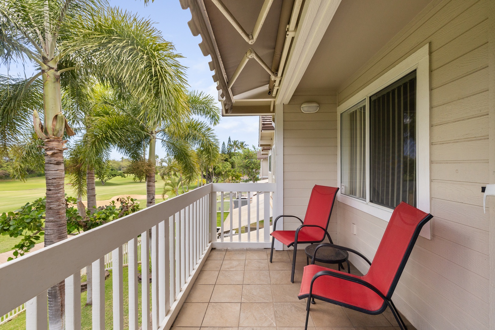 Kapolei Vacation Rentals, Fairways at Ko Olina 7A - Unwind on your private lanai with tropical golf course views, comfortable seating, and swaying palm trees creating the perfect island escape.