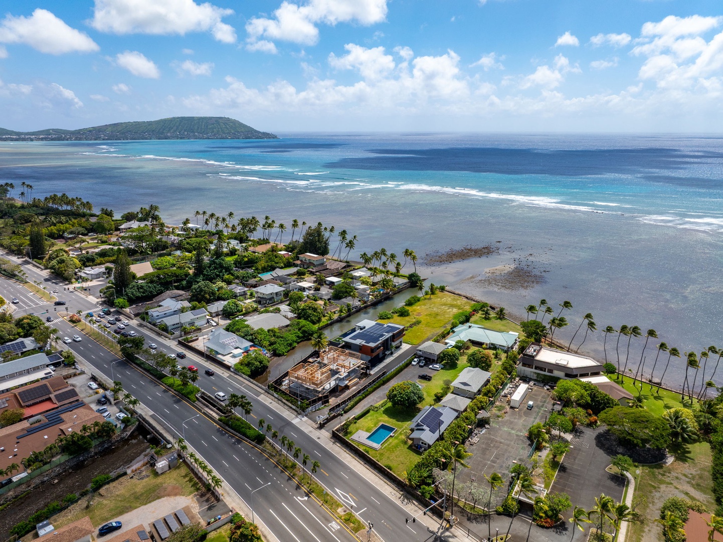 Honolulu Vacation Rentals, Ocean Villa 3 Bedroom - Stunning aerial view of tropical coastal neighborhood with pristine beaches, turquoise waters, and lush palm trees defining this Hawaiian paradise setting.