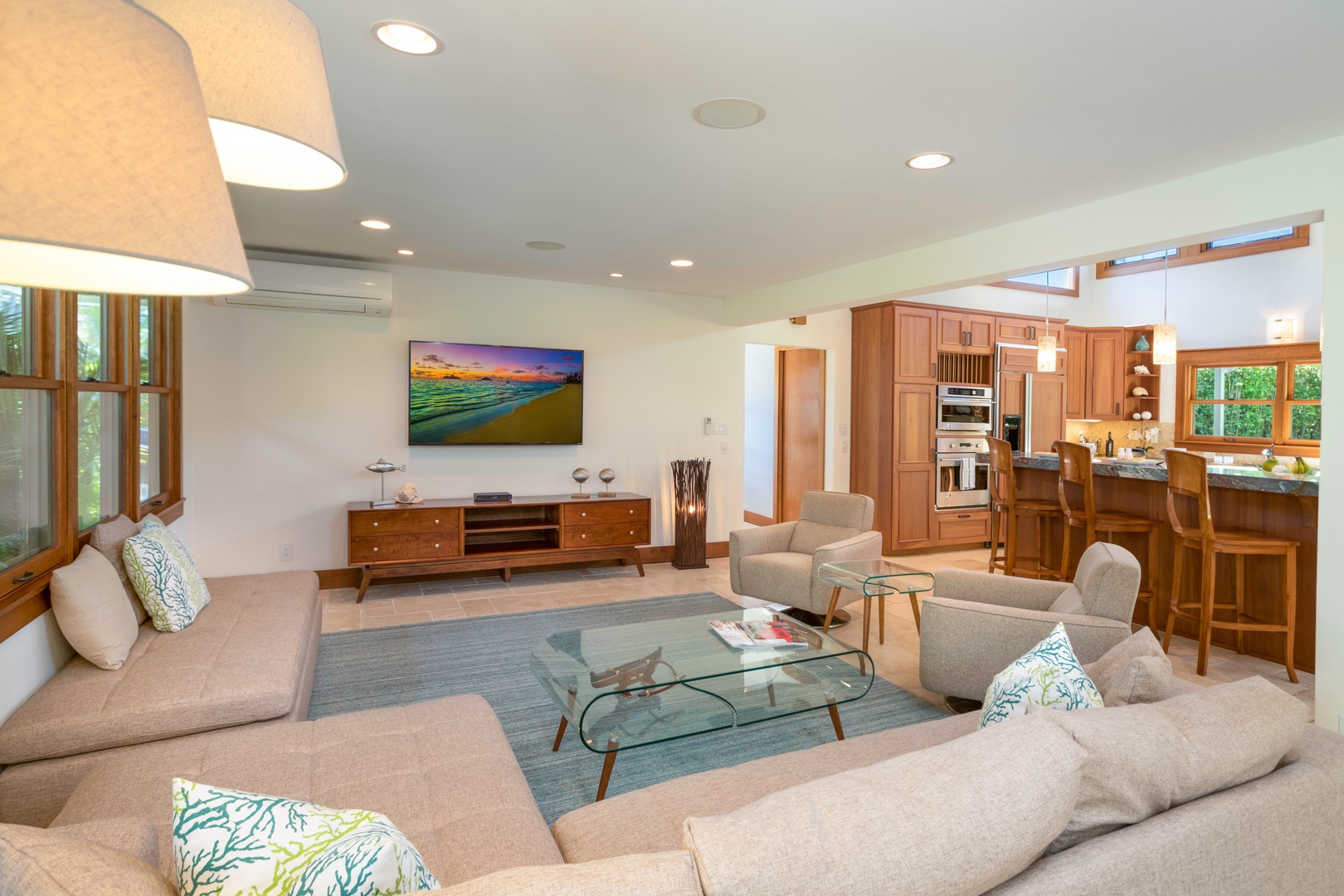 Honolulu Vacation Rentals, Hale Niuiki - Unwind in the integrated living space, featuring a spacious L-shaped couch for group movie nights, seamlessly connected to the kitchen and dining areas.