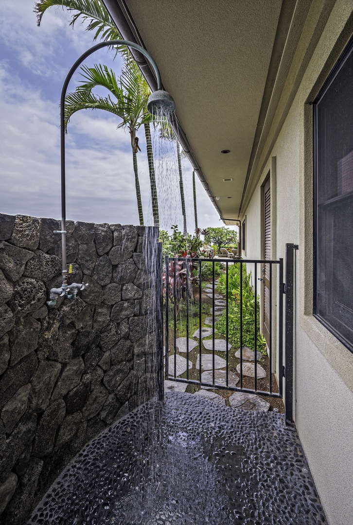 Kailua Kona Vacation Rentals, Alohi Kai Estate** - Half bath off living room has a custom designed concrete trough sink and modern designed wood slat wall panels. Outdoor shower connects to this half bath