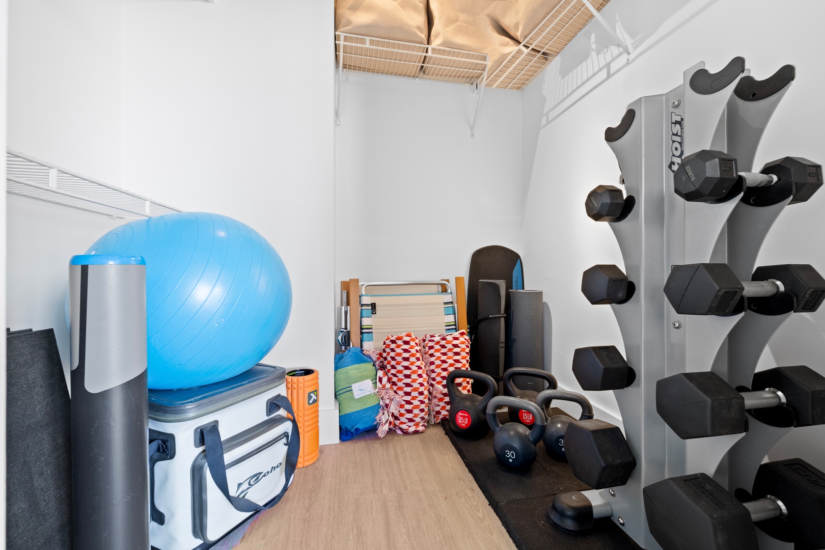 Honolulu Vacation Rentals, Hale Pono Waikiki - Stay active and energized with this dedicated home gym, equipped with weights, a workout bench, and space for yoga.