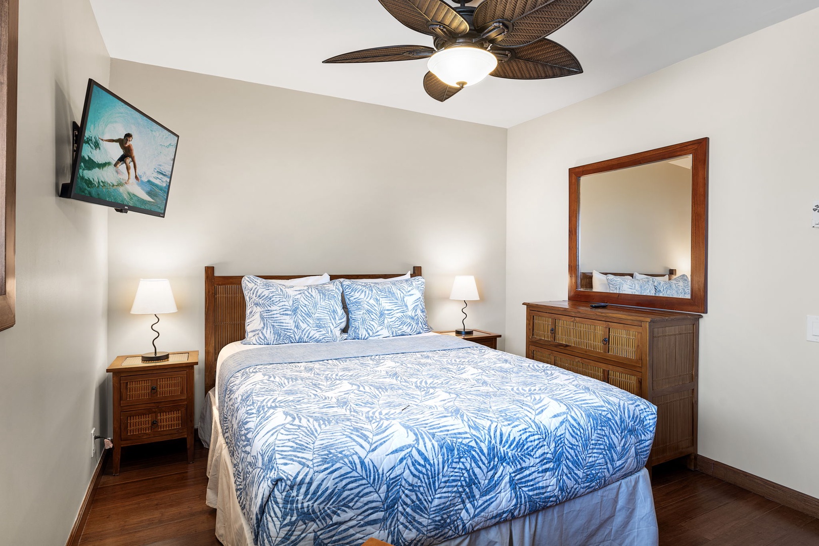 Kailua Kona Vacation Rentals, Royal Kahili 401A - Spacious bedroom featuring a queen-sized bed, wooden dresser, and tropical decor.