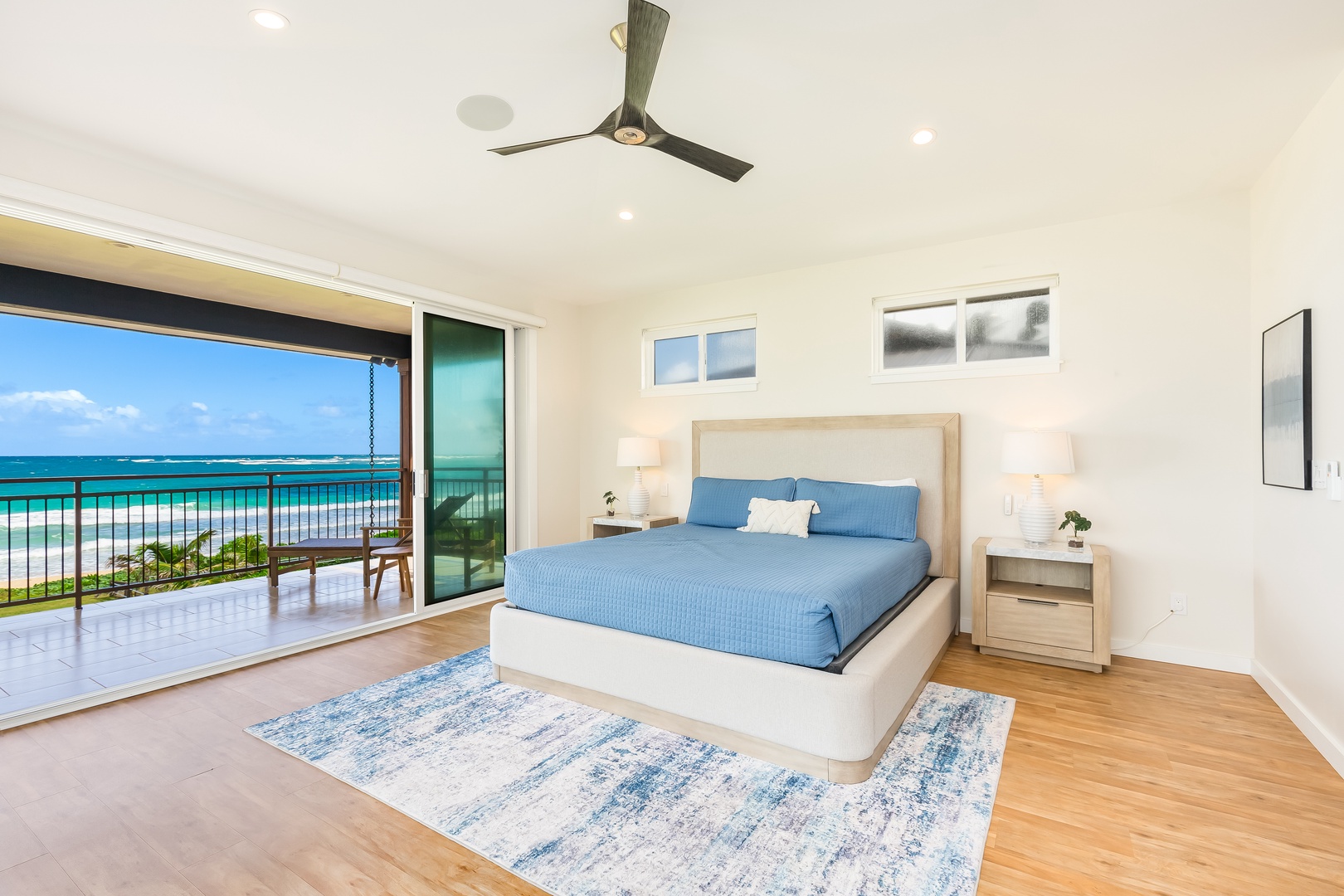 Laie Vacation Rentals, Majestic Mahakea Oceanfront Oasis - Luxurious primary bedroom featuring a king-size bed, ocean views, and direct lanai access.