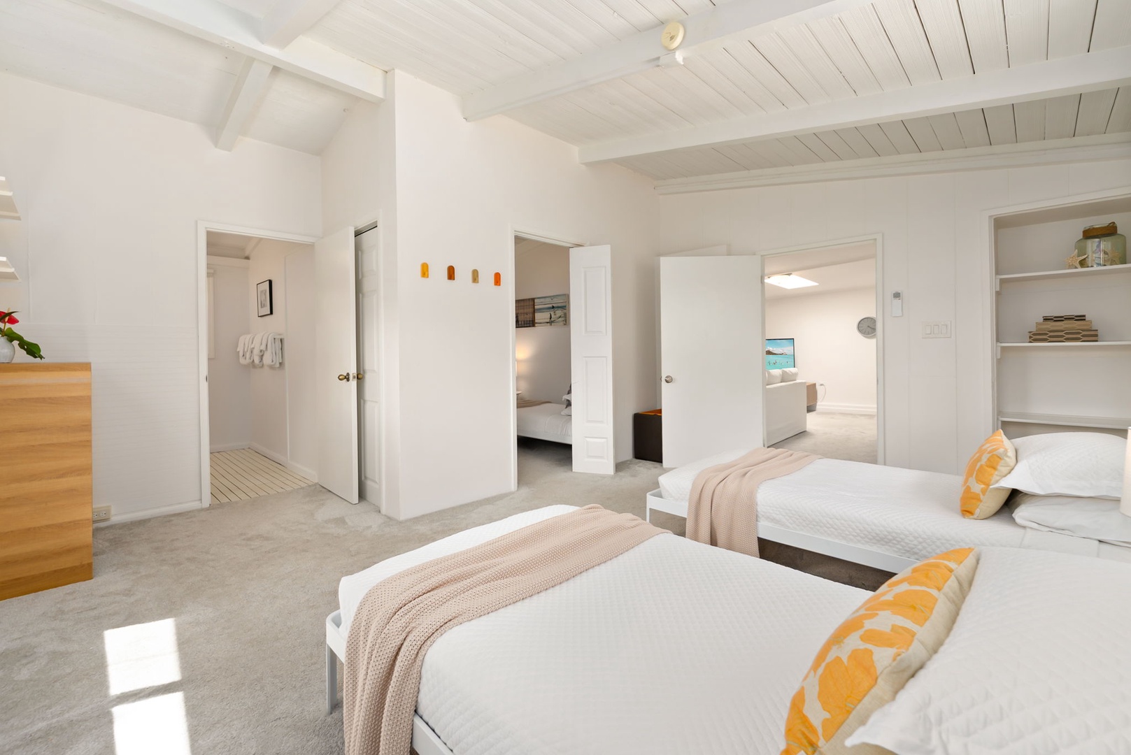 Honolulu Vacation Rentals, Ho'okipa Villa - Your spacious retreat features two plush beds with bright accents, vaulted ceilings, and connecting rooms—perfect for restful mornings and flexible comfort throughout your stay.