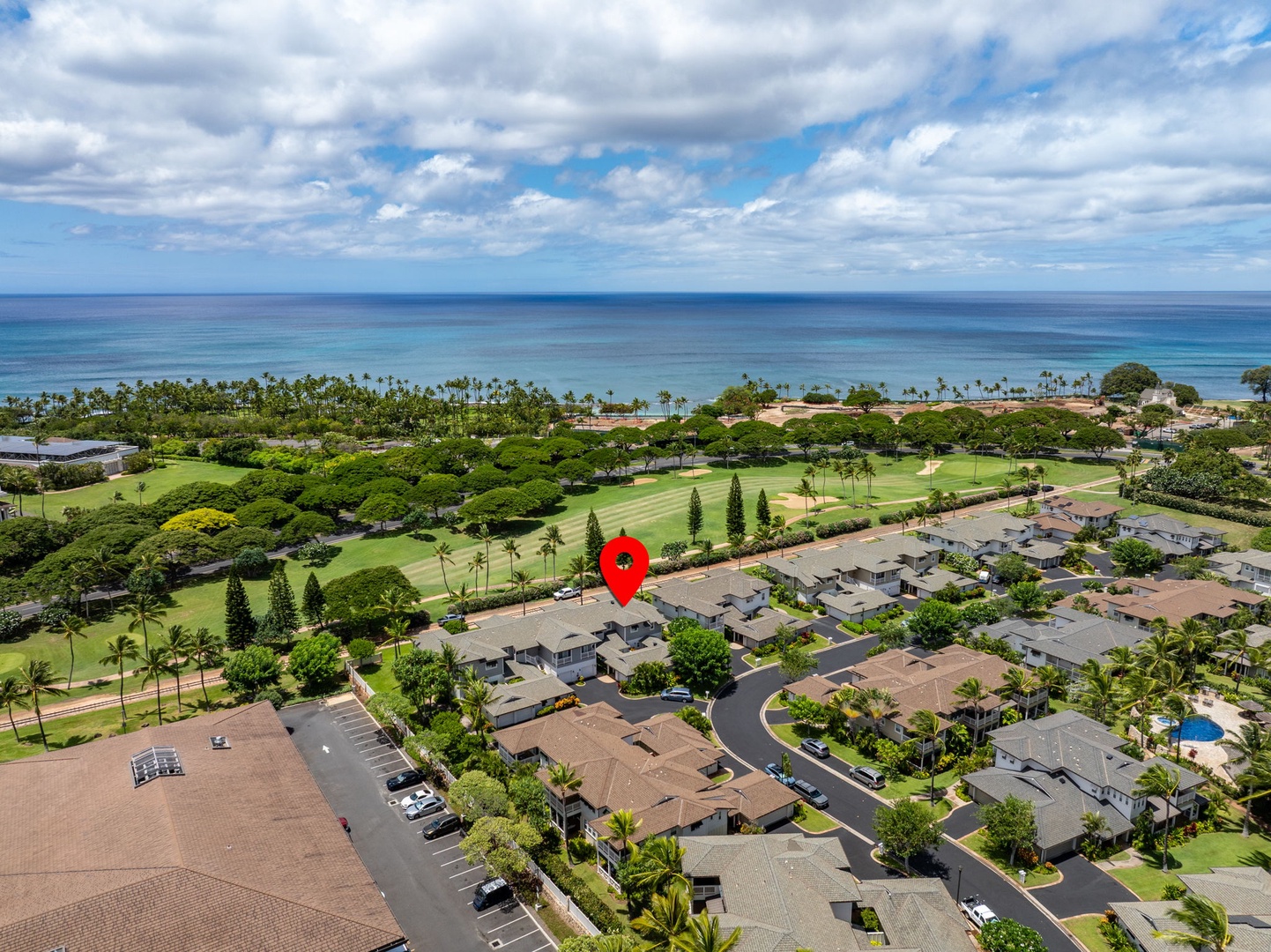 Kapolei Vacation Rentals, Coconut Plantation 1080-4 - A wide aerial places the home near the coast with the ocean on the horizon.