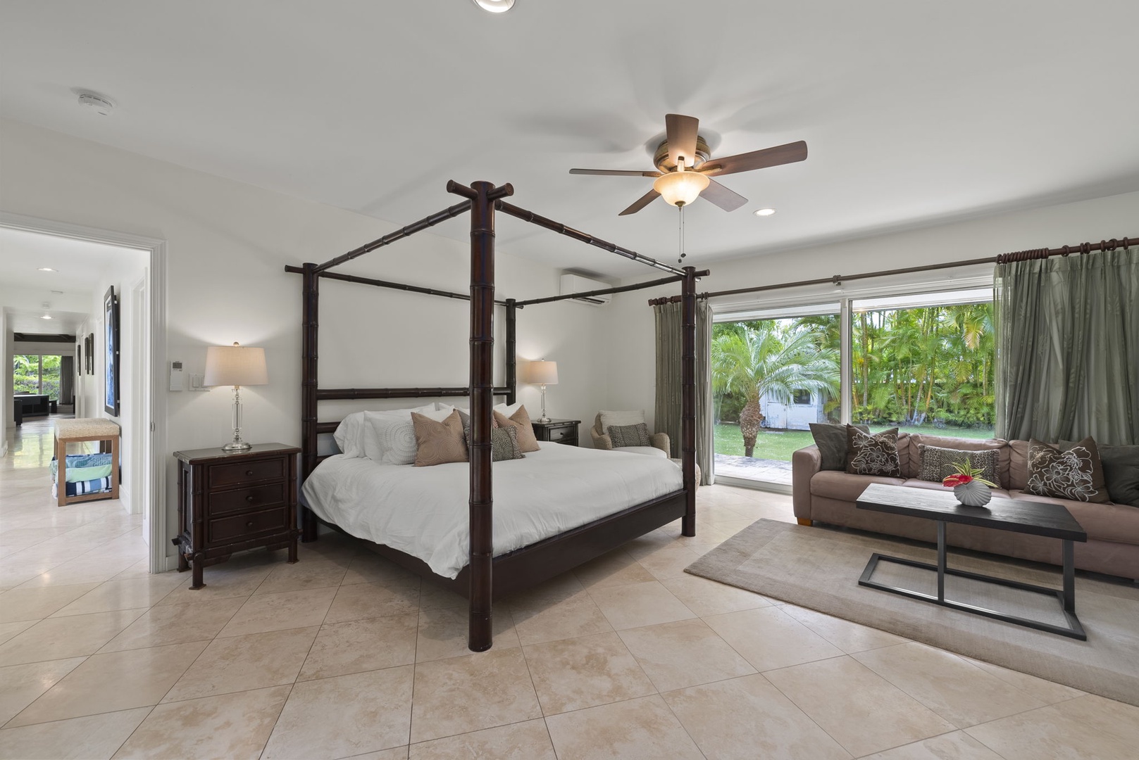Honolulu Vacation Rentals, Kahala Lani - Primary suite with elegant four-poster bed and serene garden views.