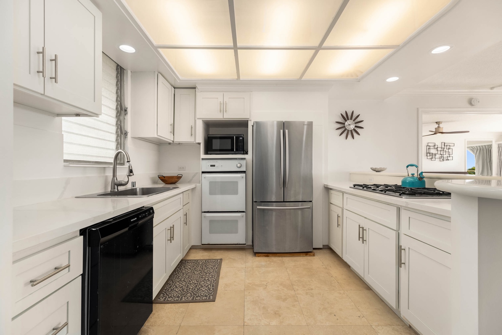 Honolulu Vacation Rentals, Colony Surf Getaway - Contemporary kitchen equipped with top-of-the-line appliances for a seamless cooking experience.