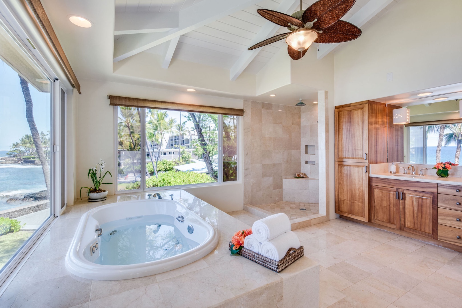 Kailua Kona Vacation Rentals, Kona Beach Bungalows** - Experience tranquility in the spacious spa-like ensuite, featuring a walk-in shower and thoughtful privacy blinds on expansive windows framing ocean vistas
