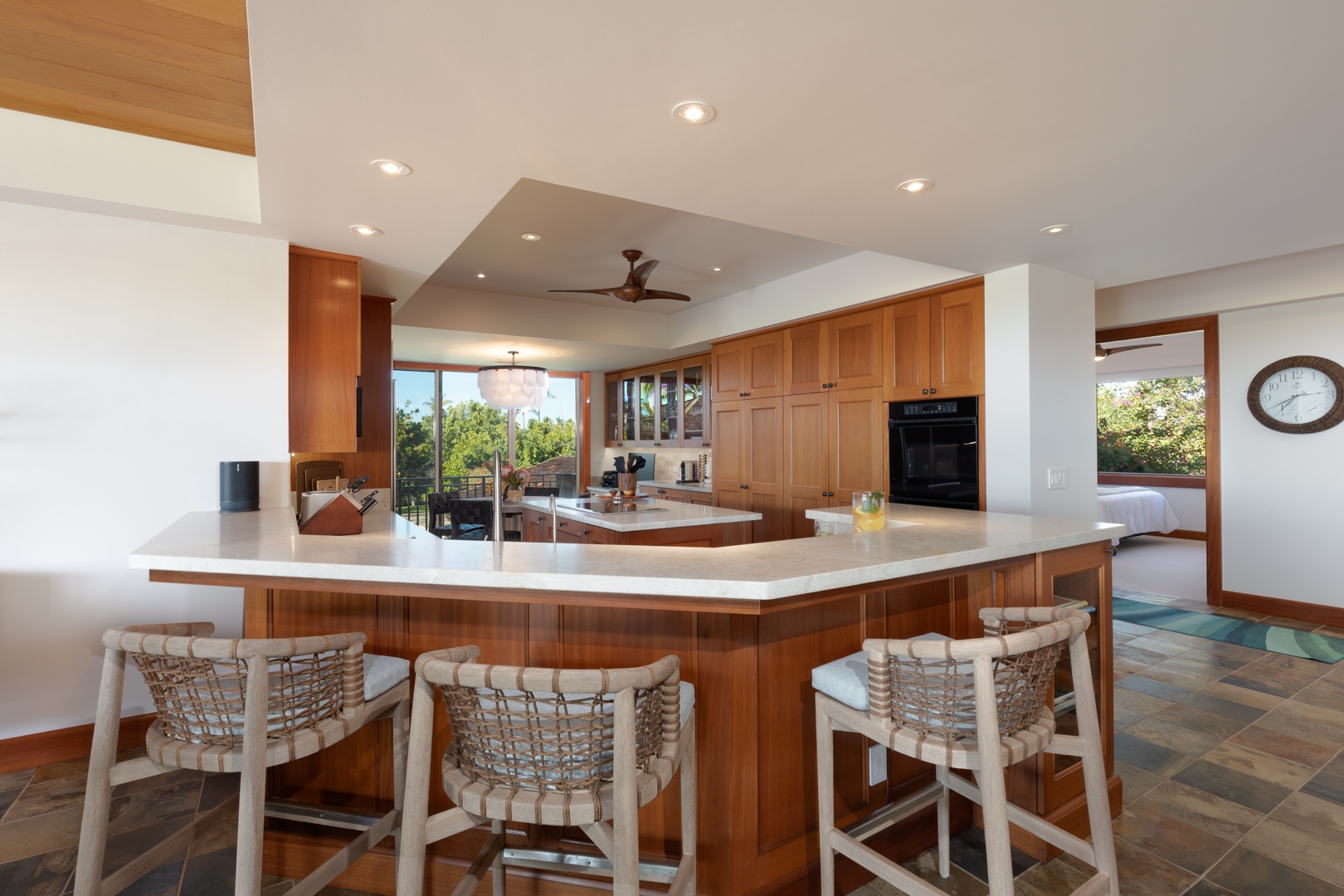 Kailua Kona Vacation Rentals, 3BD Waiulu Villa 111D at Hualalai Resort - Open-concept kitchen and dining area with bar seating for three and a warm ambiance.