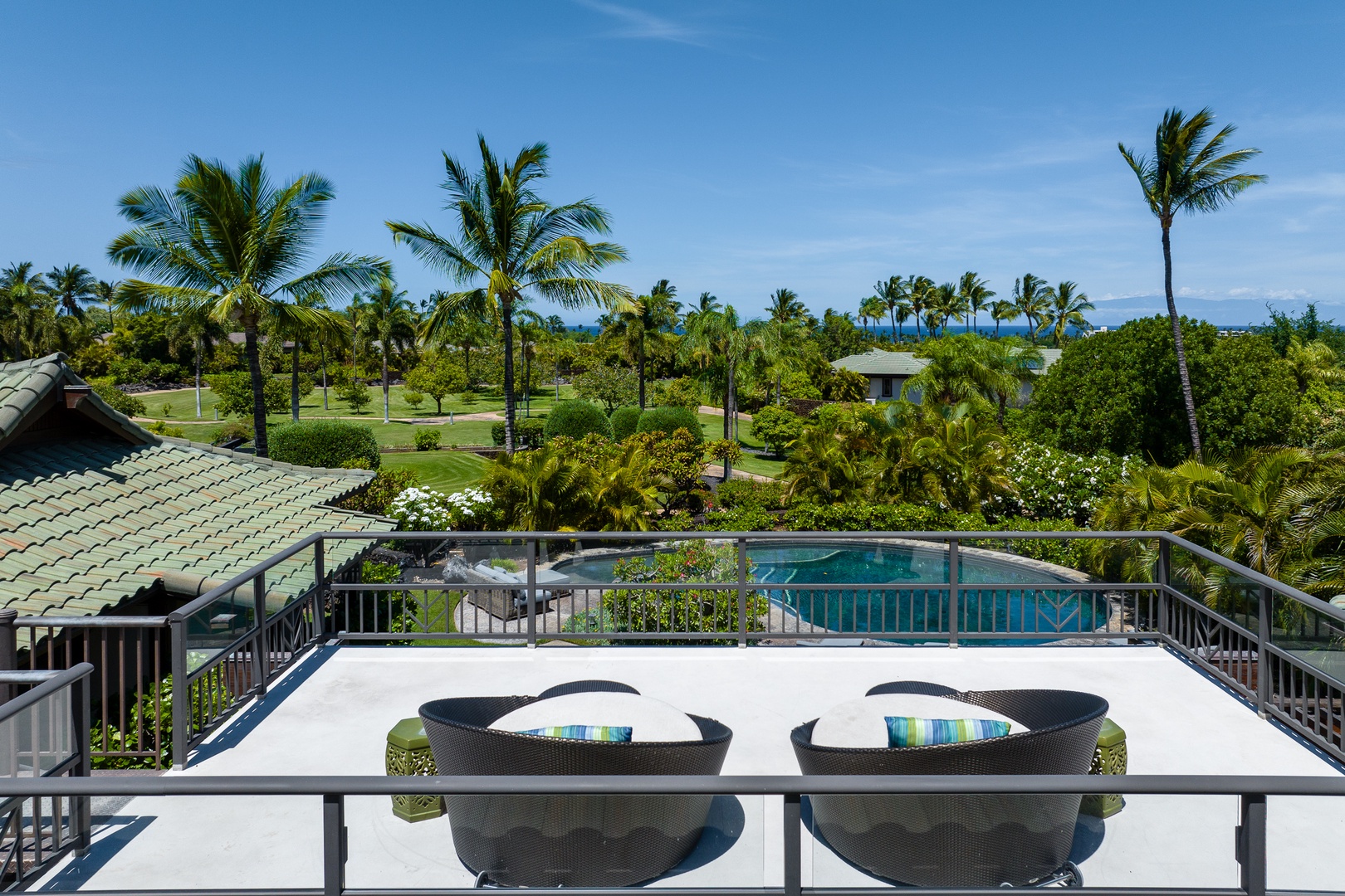 Kamuela Vacation Rentals, Mauna Lani Champion Ridge 22 - Relax on the sun beds while enjoying views of the lush greenery and pool.