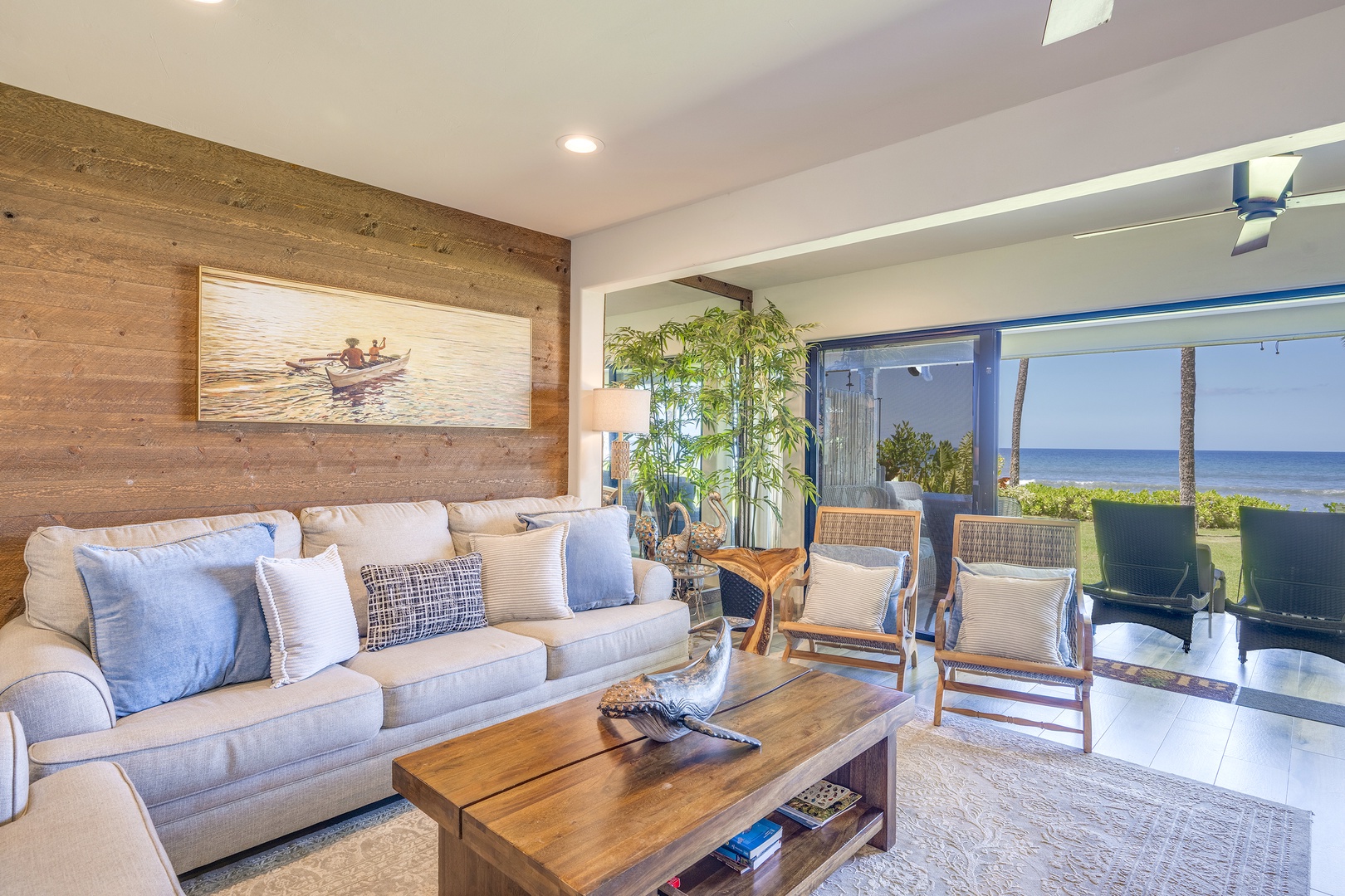Lahaina Vacation Rentals, Puamana 240-3 - Stylish living area blending modern design with warm wooden tones and tropical flair.