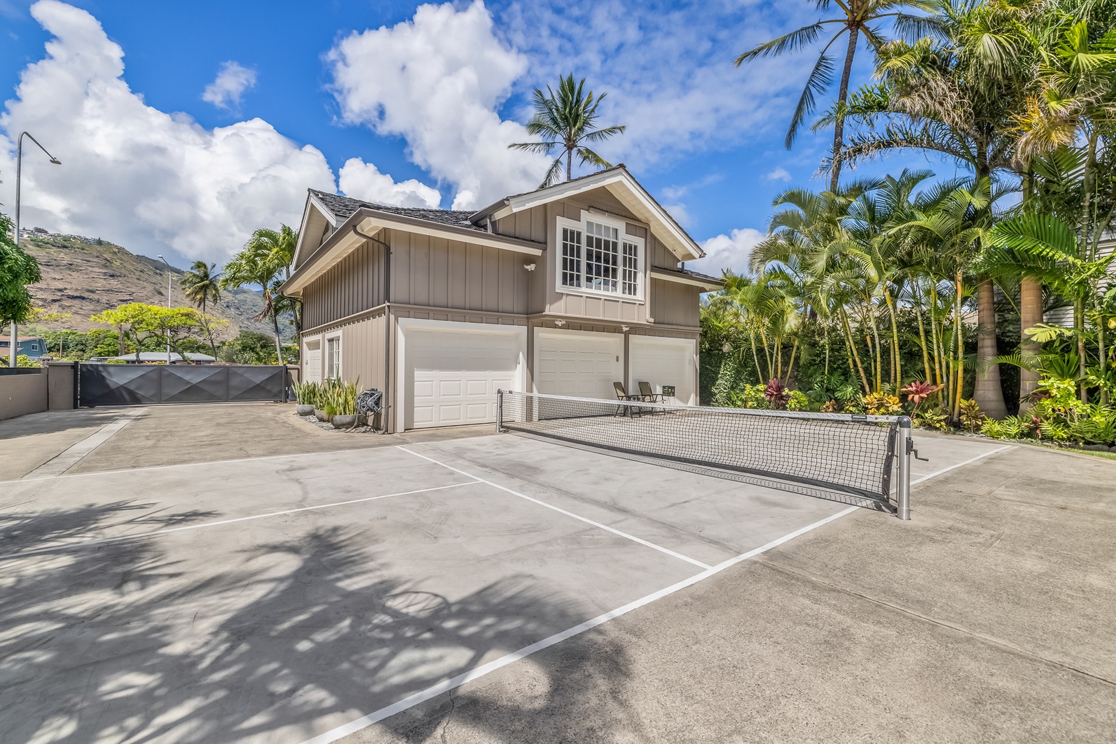 Honolulu Vacation Rentals, Moana Lani - Main House - Pickleball on the paved court by the garage, for the afternoons the group wants a rematch.