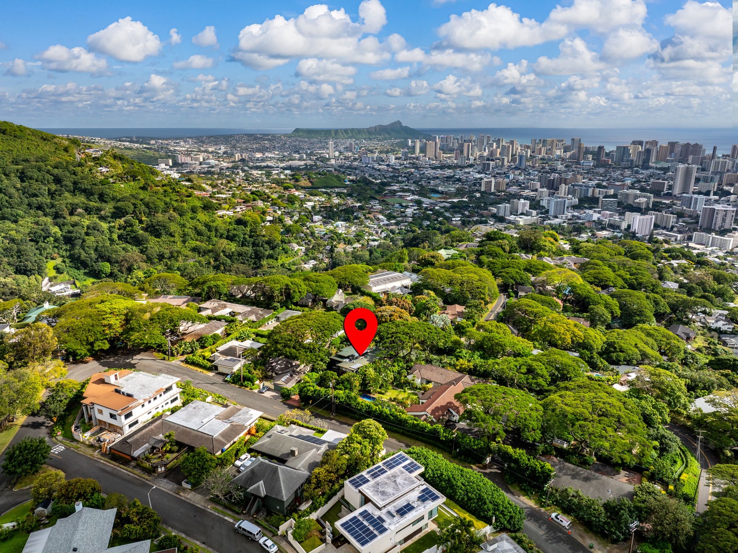 Honolulu Vacation Rentals, Tantalus Glass House (3 BD) - Aerial view showcasing the property's prime location in a lush residential neighborhood with Honolulu's skyline and Diamond Head crater in the distance.