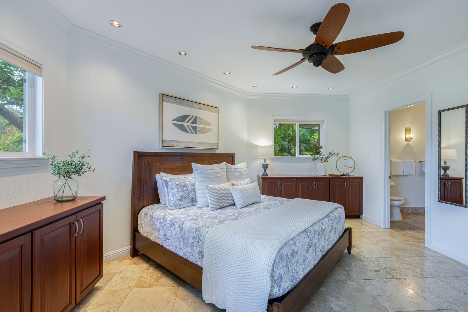 Princeville Vacation Rentals, Ohana Kamalani - Elegant king bedroom with ceiling fan, large window, and tropical accents for guest comfort.