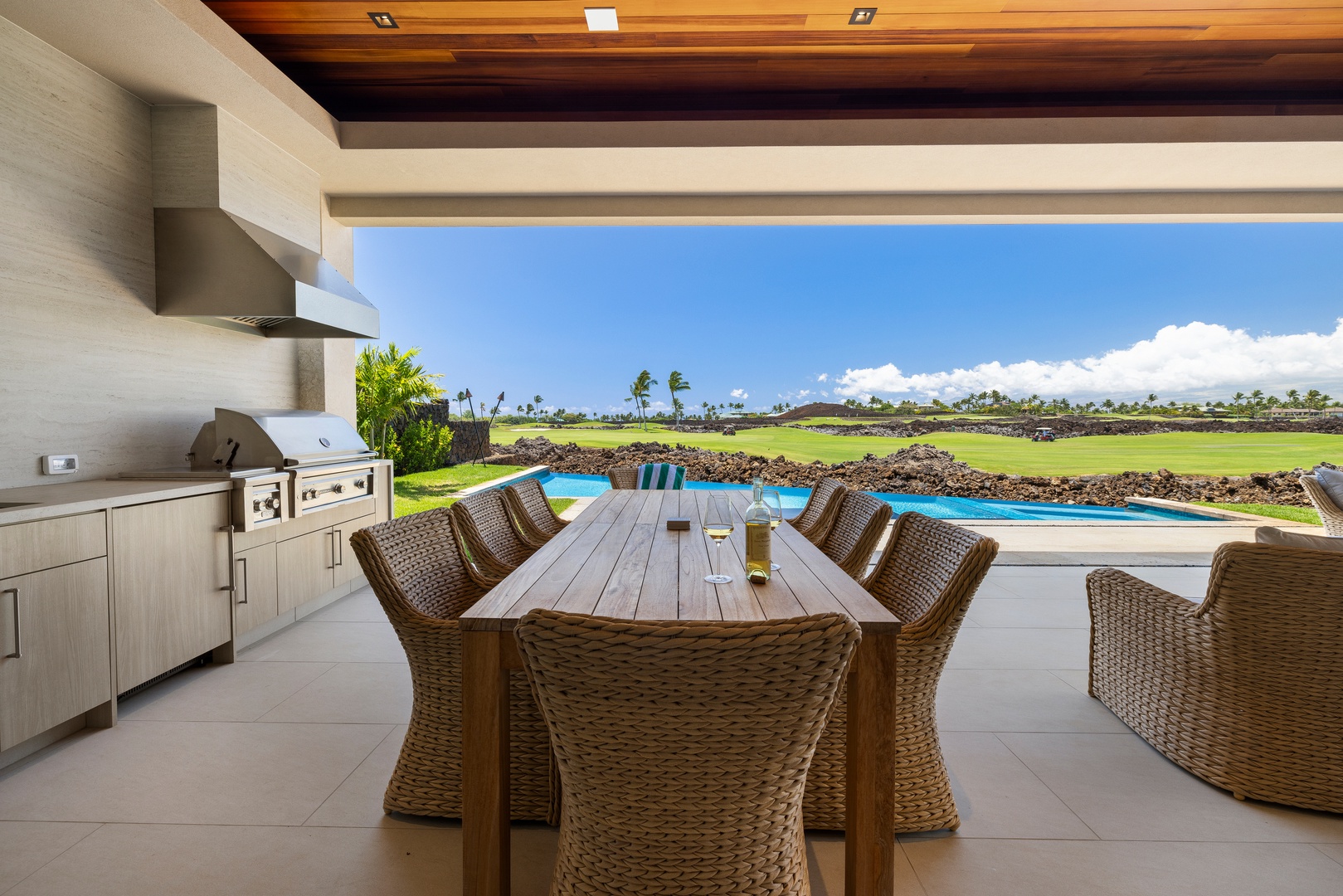 Kamuela Vacation Rentals, 6BD Mauna Lani Lux Golf Estate (5) at One Ocean - The exterior dining table sits where the green fills the view behind it.