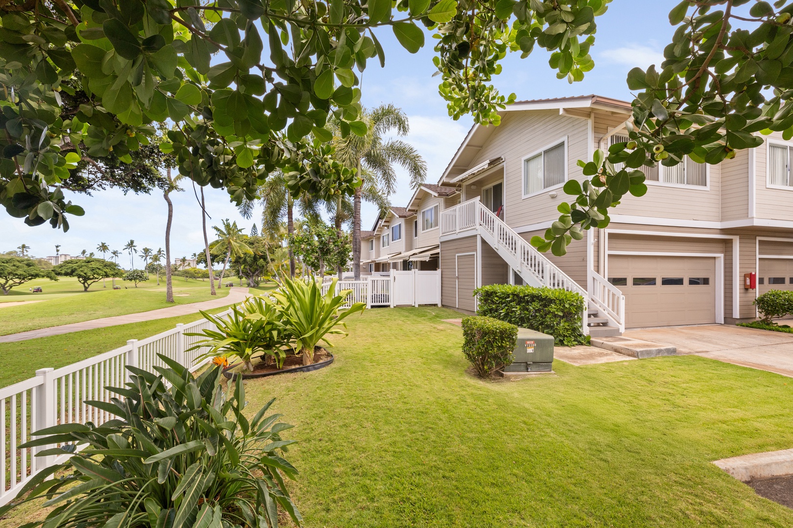Kapolei Vacation Rentals, Fairways at Ko Olina 7A - Tropical vacation home nestled among lush palm trees and manicured lawns with convenient parking and peaceful residential setting.