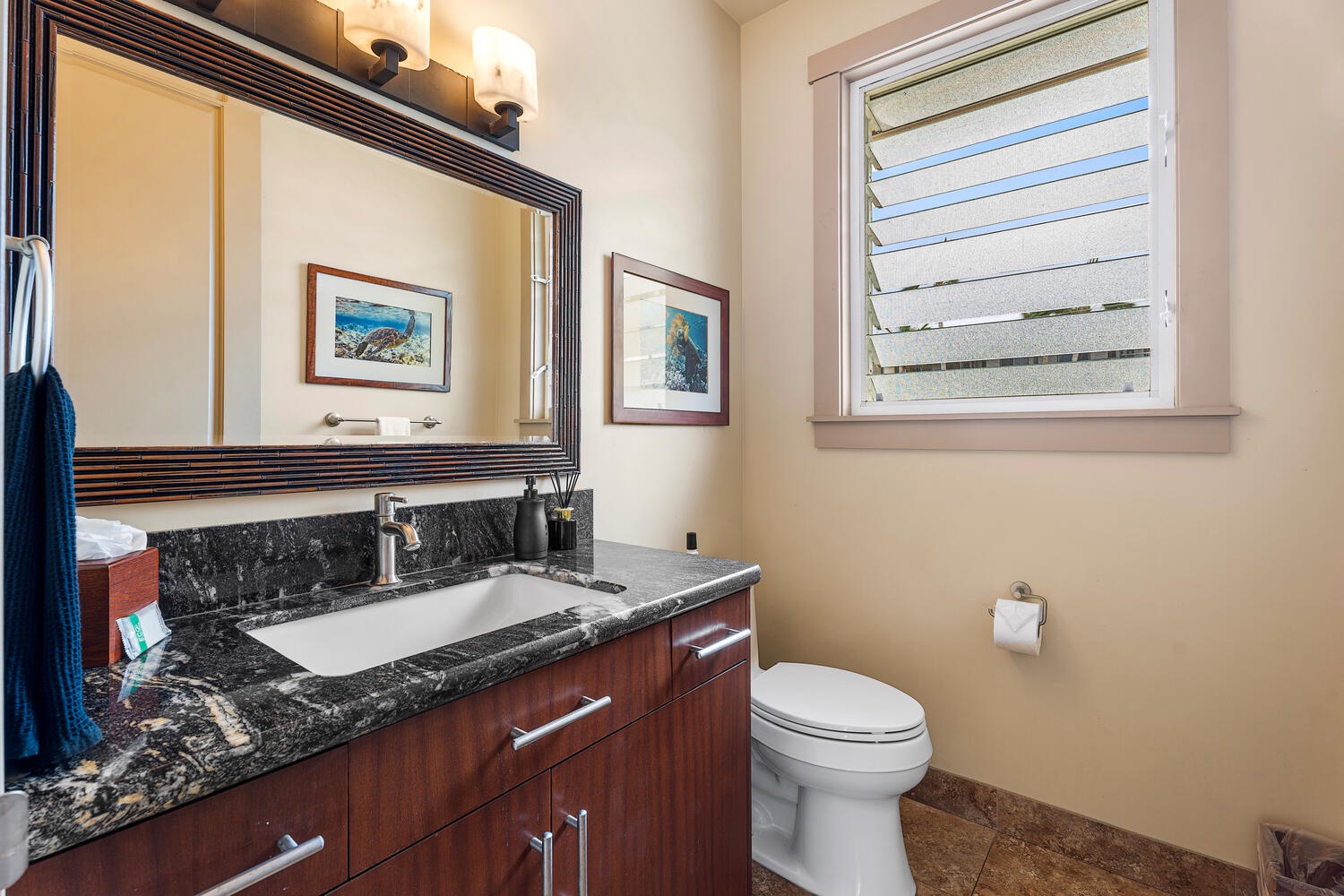 Kailua Kona Vacation Rentals, Kailani Vista - Stylish black-granite vanity and coastal artwork add flair to life’s little necessities.