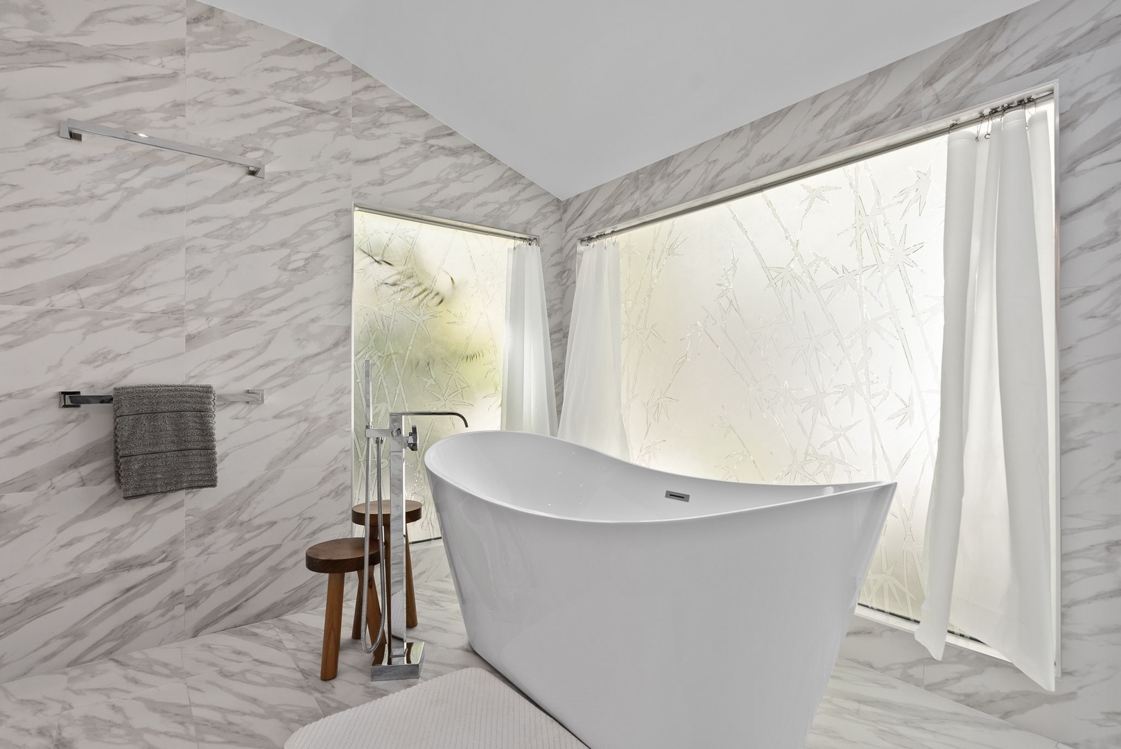 Honolulu Vacation Rentals, The Lagoon House 3BR - Freestanding tub set against marble walls, softly lit for a calming atmosphere.