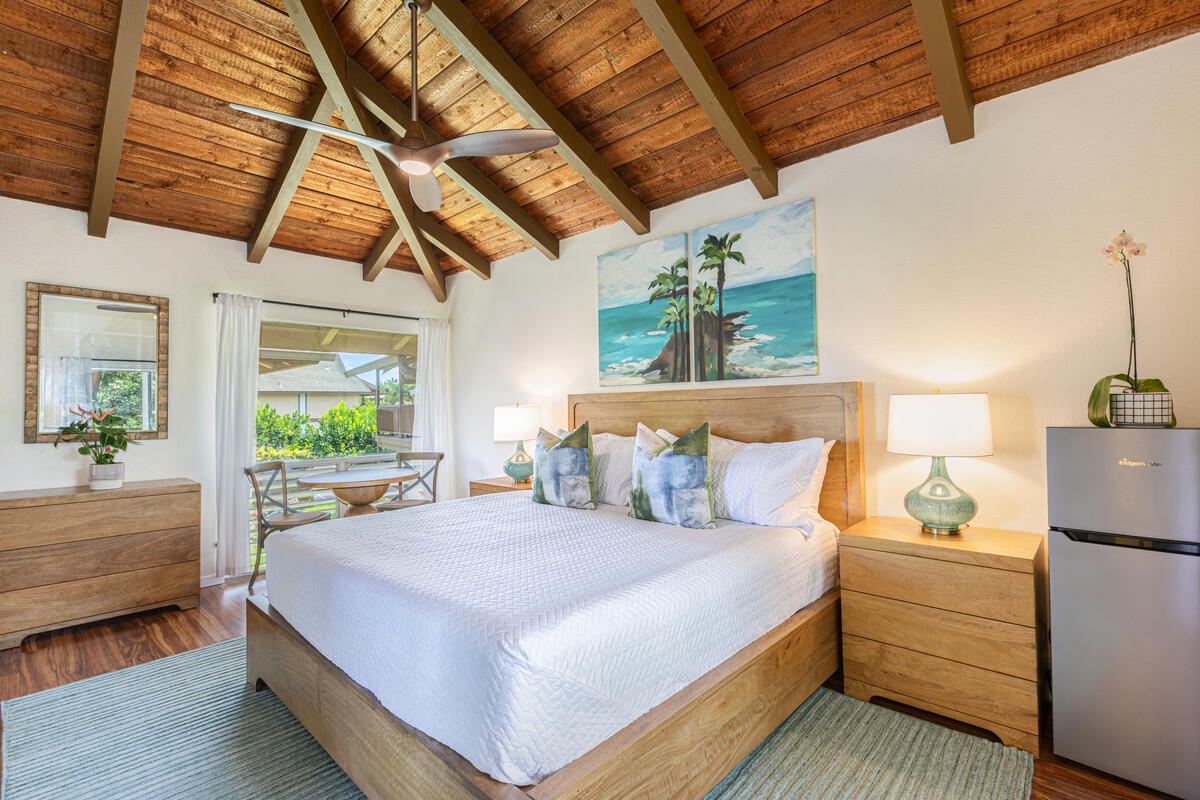 Princeville Vacation Rentals, Hale Ho'omaka Studio - This airy bedroom features soft lighting, serene tones, and easy access to the lanai for peaceful mornings.